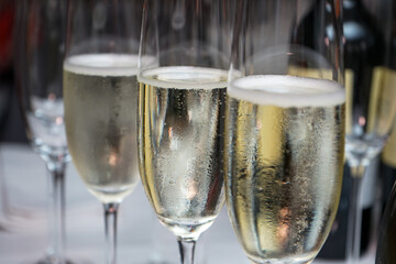 three glasses of prosecco on a set table
