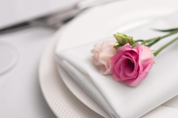 Beautiful table setting with rose flowers.