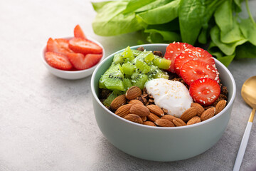 Granola with yogurt, kiwi, almond nuts, strawberry