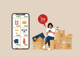 Woman sitting on the package, Shopping online using mobile phone. Customer selects the goods to online shopping . Girl with smartphone and credit card. 
