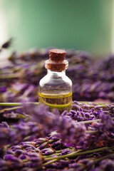 Bottle with lavender oil and a fresh bouquet of flowers