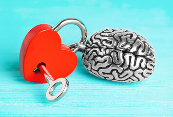 Steel brain attached to a heart-shaped padlock