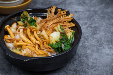 Vegan rice and vegetables bowl- rice topped with a mix of Asian mushrooms, bok choy  stewed in a savory soy based sauce