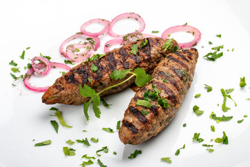 Pork kebab with greens. Isolated on a white background