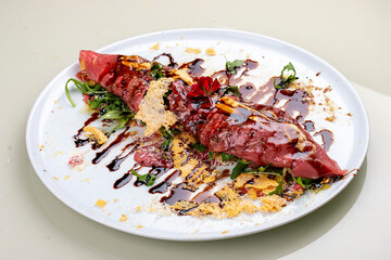 Raw beef tartare with parmesan cheese and wine sauce.