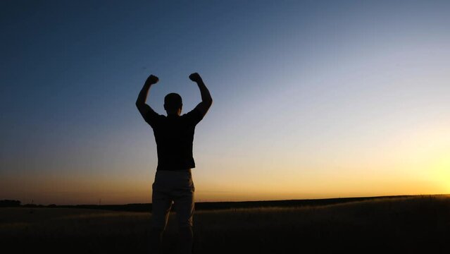 Strong powerful man flexing his arms up to the sky. Mental and physical strength concept.