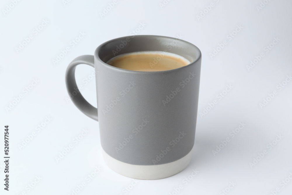 Wall mural Grey mug of freshly brewed hot coffee on white background