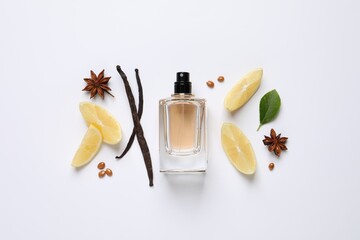 Flat lay composition with bottle of perfume, spices and lemon on white background