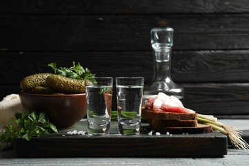 Cold Russian vodka with snacks on wooden table