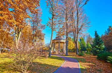 The small gazebo behind the trees in park