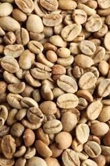 Many green coffee beans as background, top view