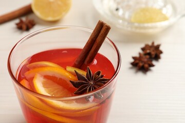 Aromatic punch drink on white table, closeup. Space for text