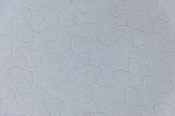 Close-up of blank white jigsaw puzzle texture background