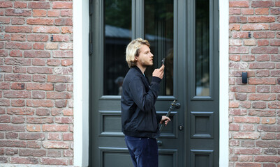 young man opening the door of his house.Inviting the guests