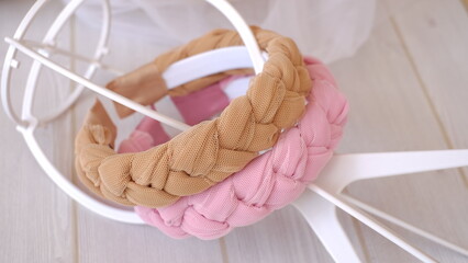 Soft pink and brown color braided headband made out of chiffon and tulle fabric texture. A hair...