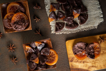 Candied oranges with chocolate. Dryed oranges and cinnamon. Top view.