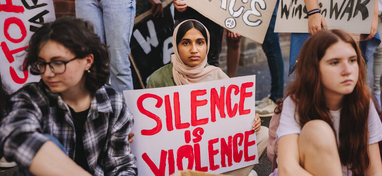 Muslim girl holding an anti-violence banner