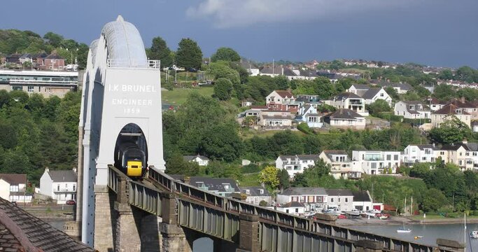The Royal Albert Bridge Over the River Tamar built by Isambard Kingdom Brunel with a GWR Train Crossing Over the Bridge on a Summer's Day in England.
