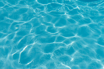 Fototapeta na wymiar Blue rippled water in swimming pool background