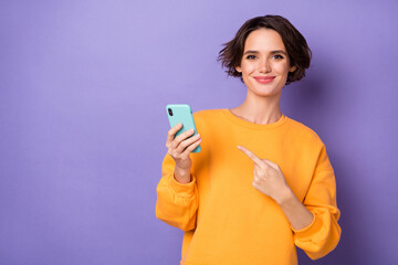 Photo of pretty young person indicate finger telephone device isolated on violet color background