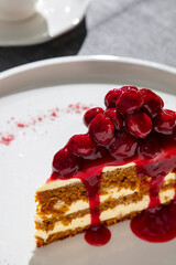 Slice of cake with cherries and cherry jam