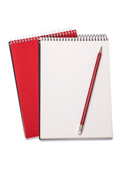 Spiral school notebooks on the table and a burgundy colored pencil. Isolated on white background.