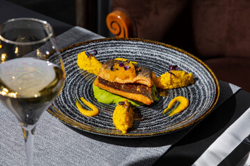 Fried fish with mashed potatoes, sprouts, mango, and sauce