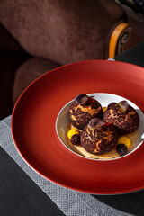 Profiteroles with chocolate crumb, blackberry, chocolate, cream and bread