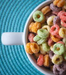 Top view of a rounded colored cereal bowl over Blue Background.