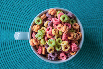 Top view of a rounded colored cereal bowl over Blue Background.