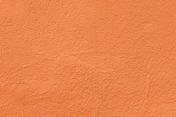 Saturated pastel orange colored low contrast Concrete textured background. Empty colourful wall...