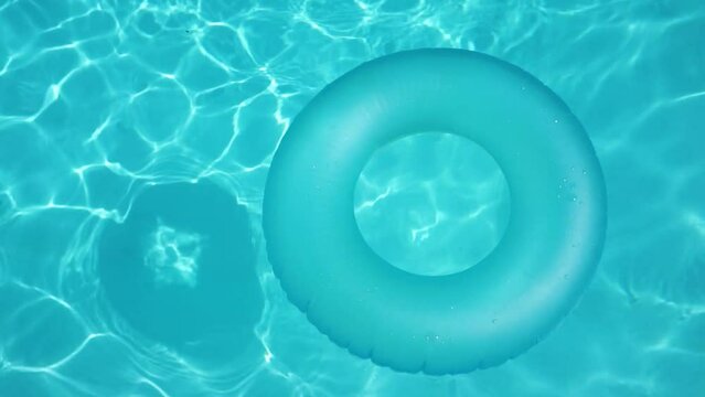 Blue summer pool rubber ring floating on a vacation swimming pool