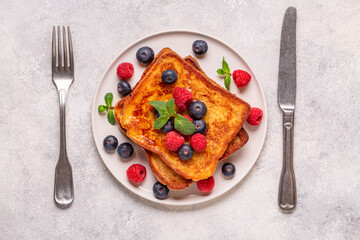 French toast with blueberries, raspberries, maple syrup