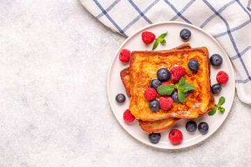French toast with blueberries, raspberries, maple syrup