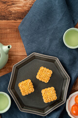 Delicious mung bean moon cake for Mid-Autumn Festival food mooncake on dark wood table background.