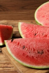 Slices of tasty ripe watermelon on wooden table, closeup