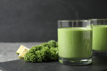 Tasty kale smoothie on black table, closeup