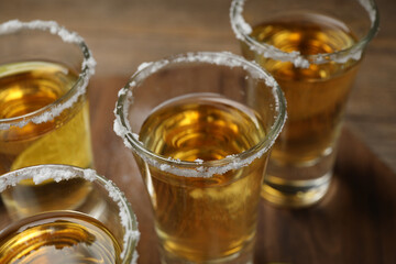 Mexican Tequila shots with salt on table, closeup