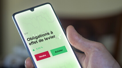 Un investisseur analyse un fonds etf obligations à effet de levier sur un graphique. Un téléphone affiche le cours de l'ETF. Texte en français francais Obligations à effet de levier