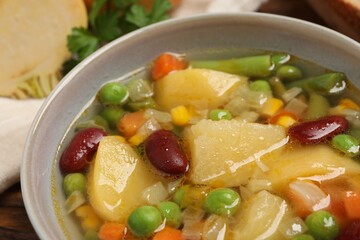 Bowl of delicious turnip soup on table, closeup view