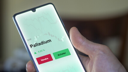 Un investisseur analyse un fonds etf palladium sur un graphique. Un téléphone affiche le cours de l'ETF. Texte en français francais Palladium
