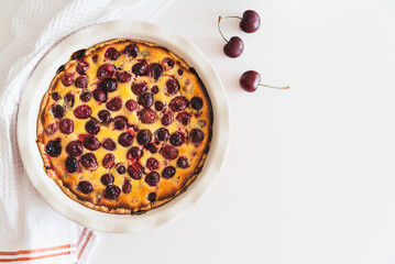 Homemade cherry cheesecake pie on white background. Top view