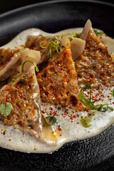 Triangular dumplings with sesame seeds, sprouts