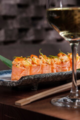 Rolls with salmon, lime peel, sesame seeds, tobiko caviar