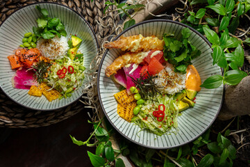 Salad with rice, sesame seeds, pieces of salmon and shrimps