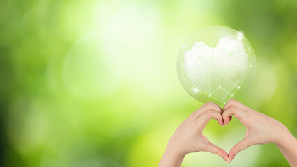 Hands heart shape and light sparkle clouds on bokeh nature background.(World Ozone Day Concept)