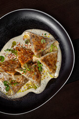 Triangular dumplings with sesame seeds, sprouts