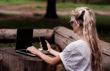 Young adult happy smiling Hispanic Asian student wearing headphones talking on online chat meeting using laptop in university campus or at virtual office. College female student learning remotely.