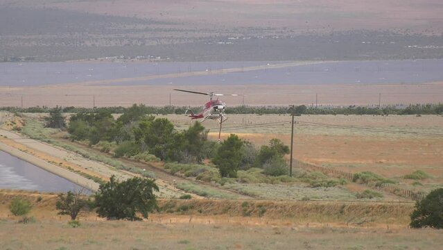 Helicopter landing in desert field 