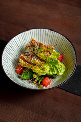Salad with broccoli, parmesan, lettuce, tomatoes